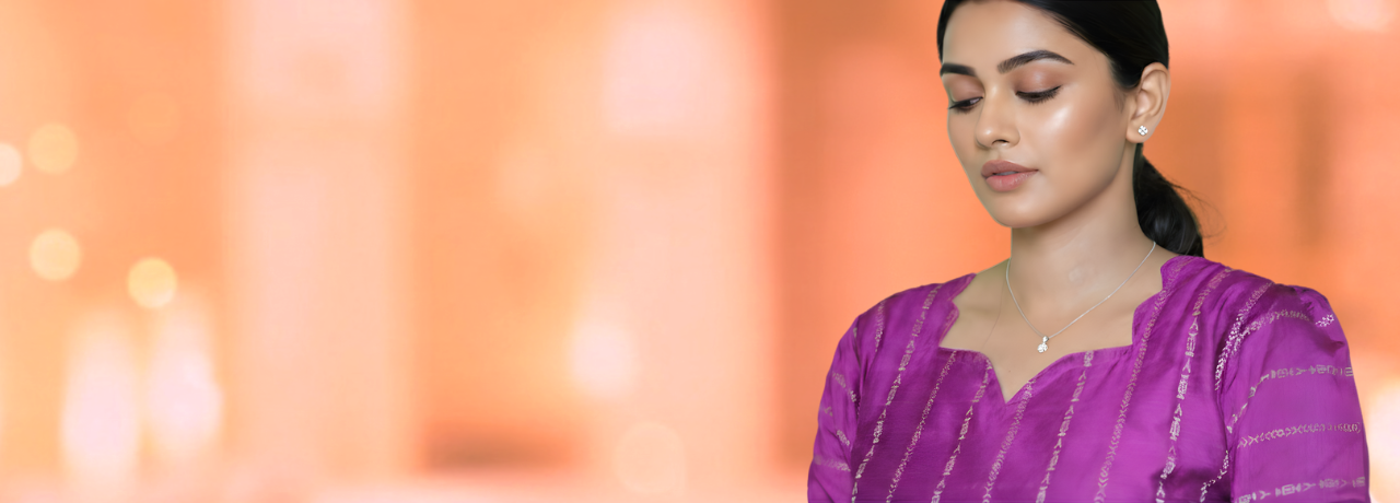 Woman wearing a purple traditional outfit against a blurred warm-toned background